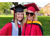 Regina Whittick, on right, and her daughter Charlotte wearing red caps and gowns at Rutgers' graduation.